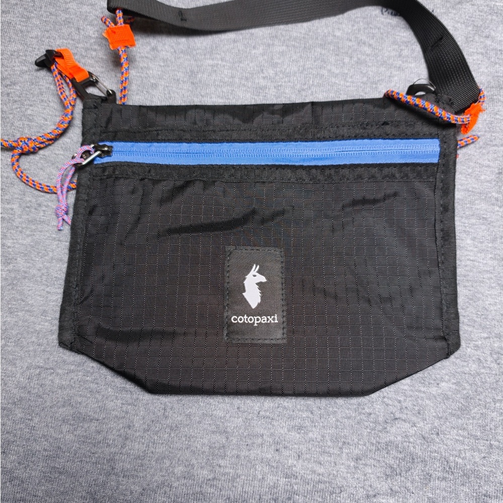 cotopaxi Black Belt Bag with Blue Zip and Orange Accents